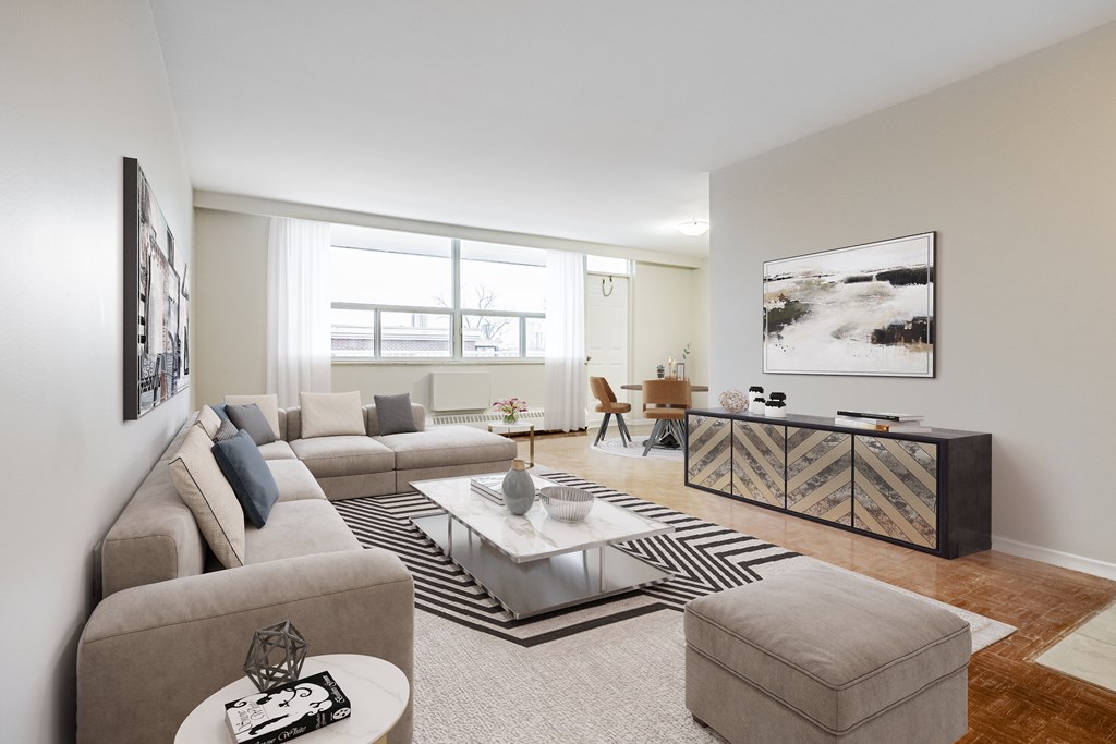 A living room with a grey sofa, a coffee table, and a rug.