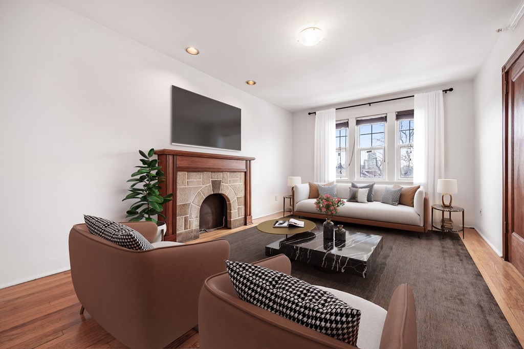 A living room with a fireplace and a television above it.