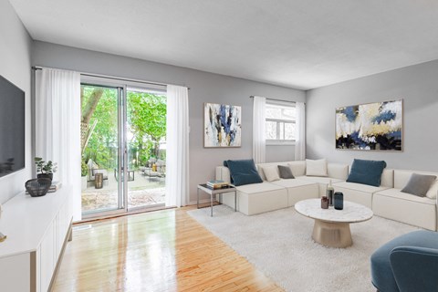 A living room with a white couch and a coffee table.