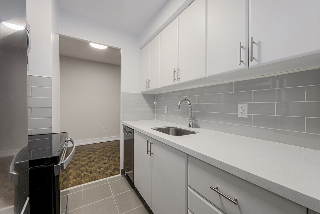 a kitchen with white cabinets and a sink