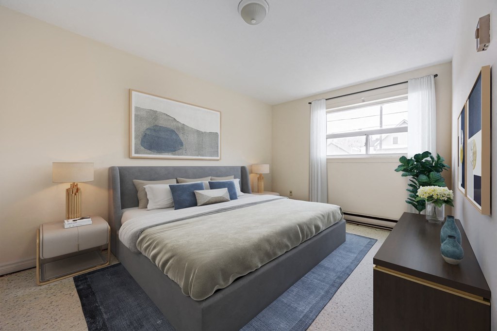 A bedroom with a large bed and a painting on the wall.