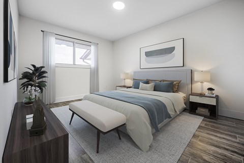 A bedroom with a large bed and a bench in front of it.