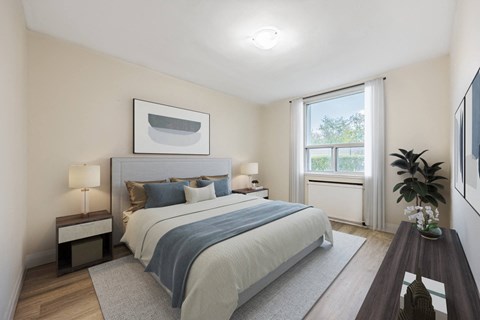 A bedroom with a large bed and a window.