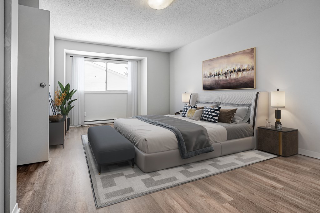 A bedroom with a large bed and a painting on the wall.