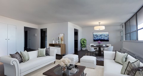 A modern living room with a white sofa and a coffee table.