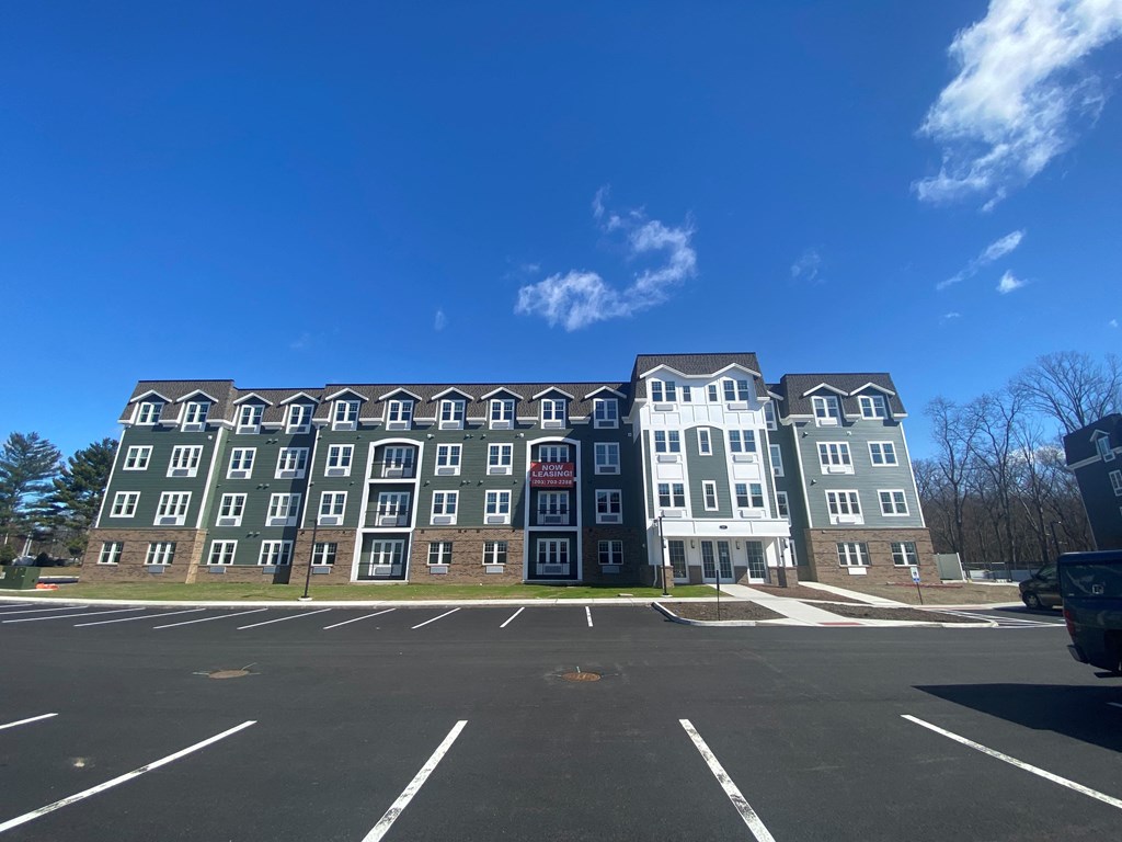 A large building with a parking lot in front of it.
