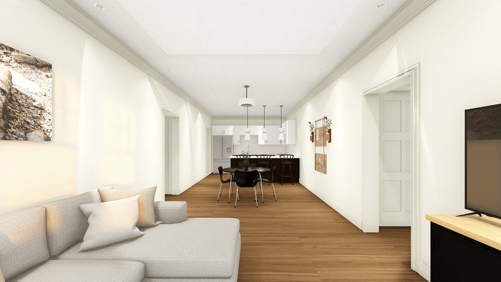 a view of a living room with a couch and a table with chairs