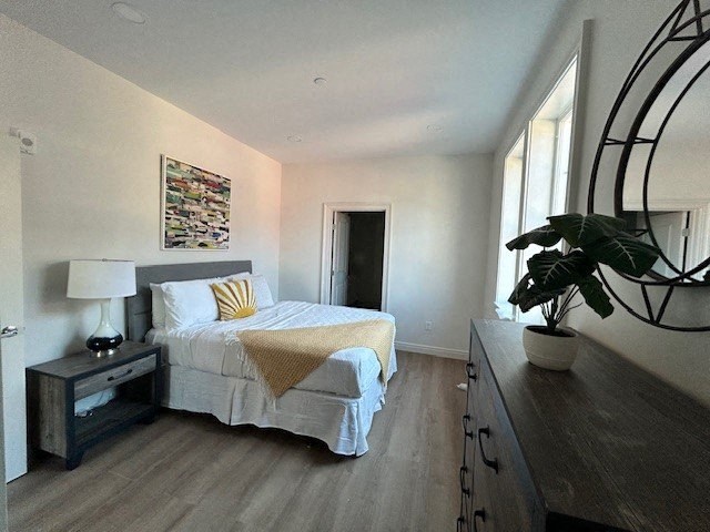 a bedroom with a bed and a potted plant