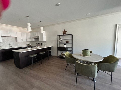 a kitchen and dining room with a table and chairs