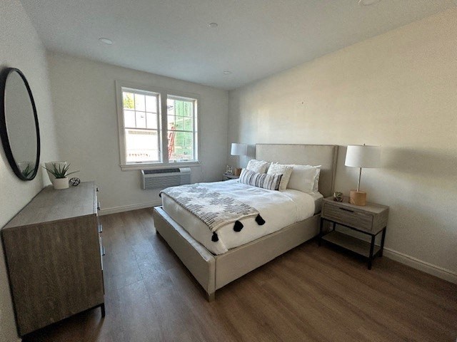 a bedroom with a bed and a dresser and a window