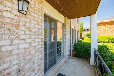 A brick wall with a black lantern on it.