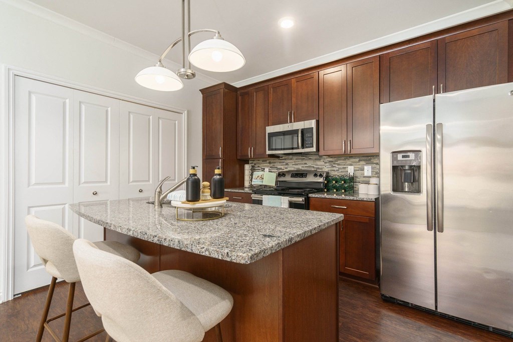 a kitchen with stainless steel appliances and a granite counter top