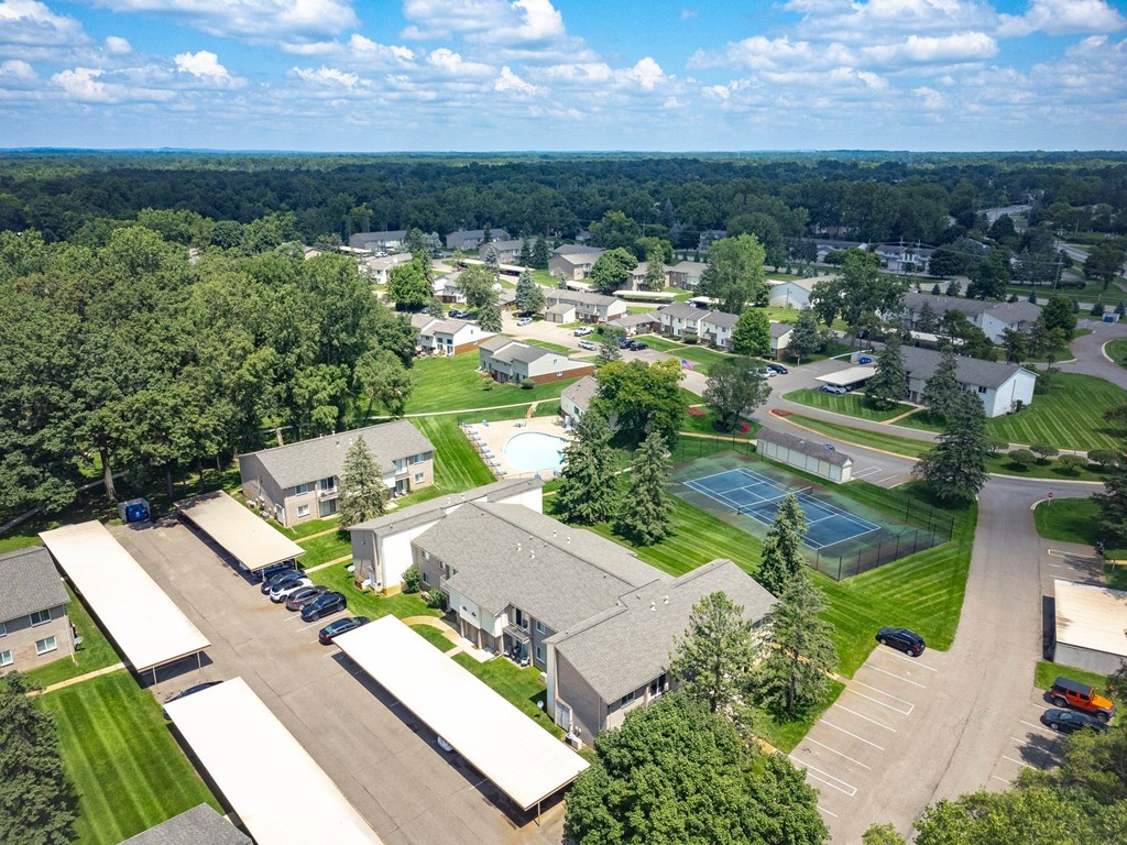 an aerial view of a neighborhood with houses and a tennis court