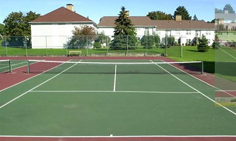 A tennis court with a net in the middle.