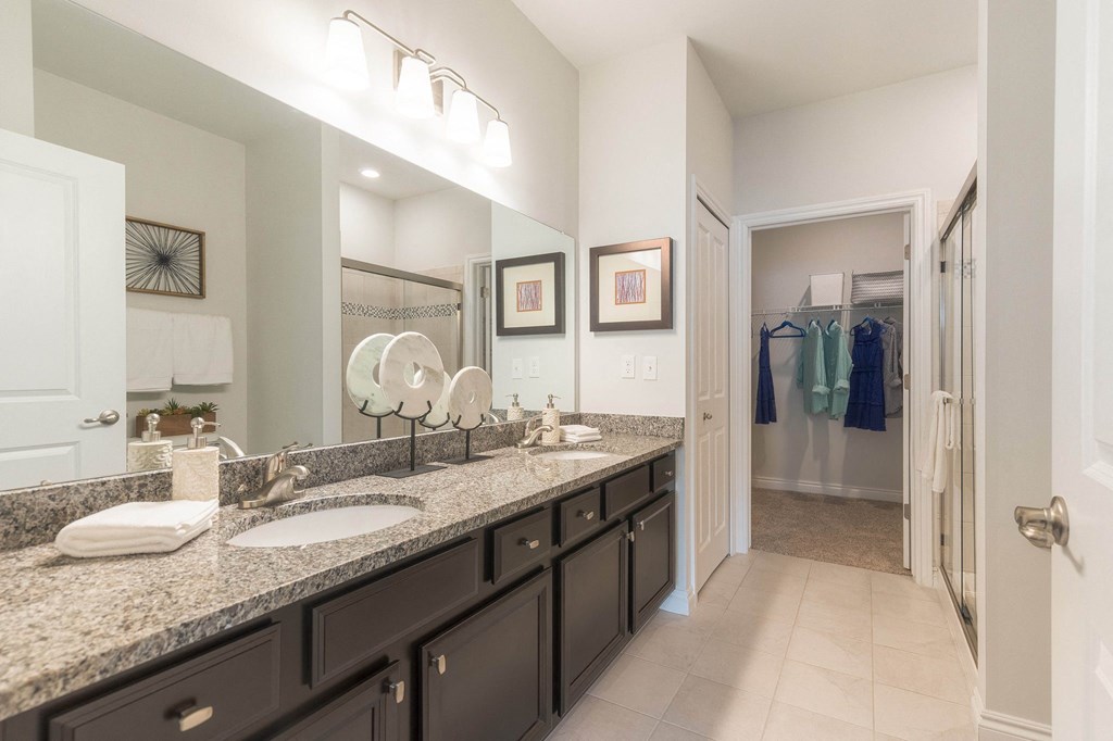a bathroom with two sinks and a large mirror