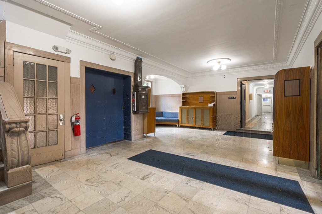 the lobby of an old building with a blue door