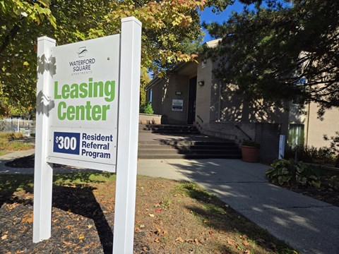 a sign that reads leasing center in front of a building