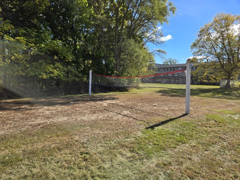 a tennis court in a park with a net