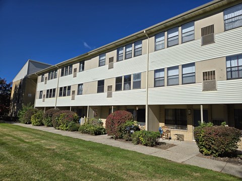 A large building with a lawn in front of it.