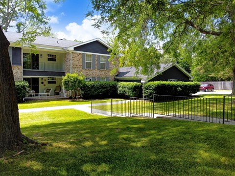 a large yard in front of a house with a fence