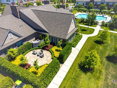 an aerial view of a house with a yard and a swimming pool