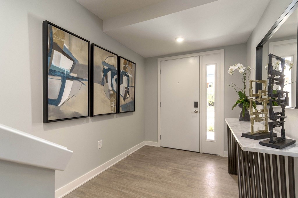 a hallway with paintings on the wall and a door