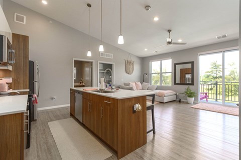 A modern kitchen with wooden cabinets and a large island.
