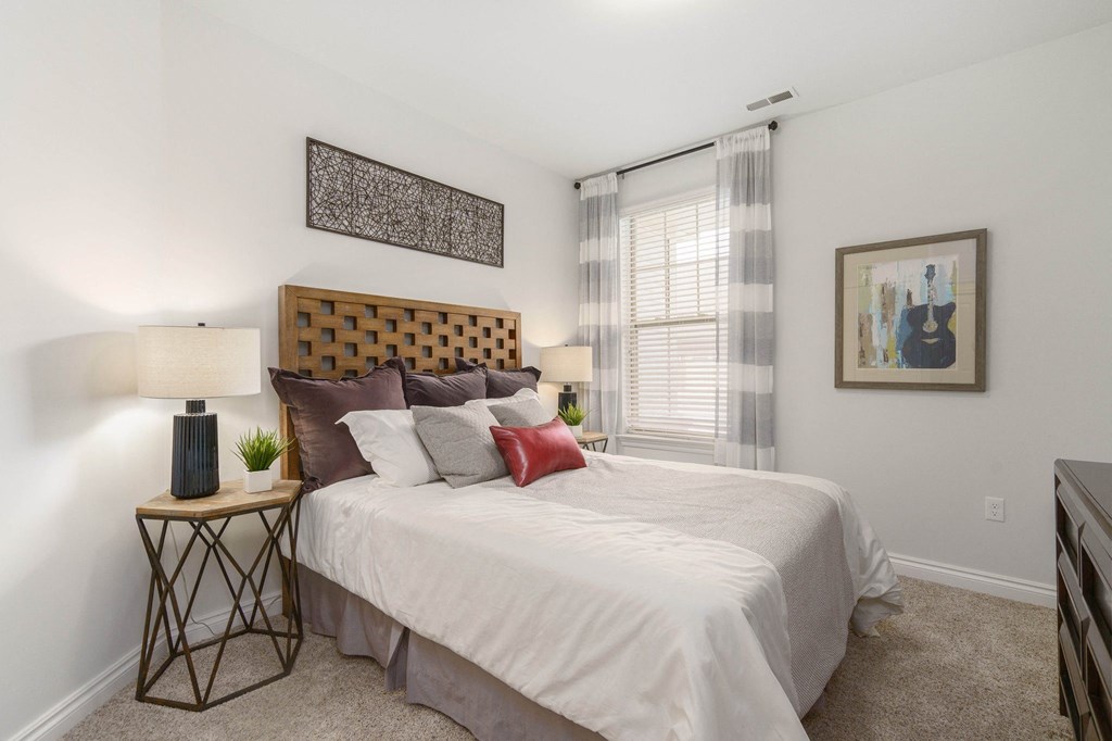 a bedroom with a large bed and a window