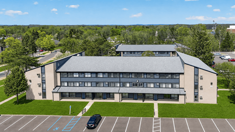 A large building with a parking lot in front of it.