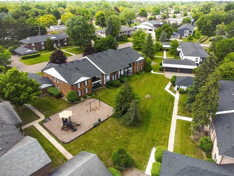an aerial view of a neighborhood with houses and a park