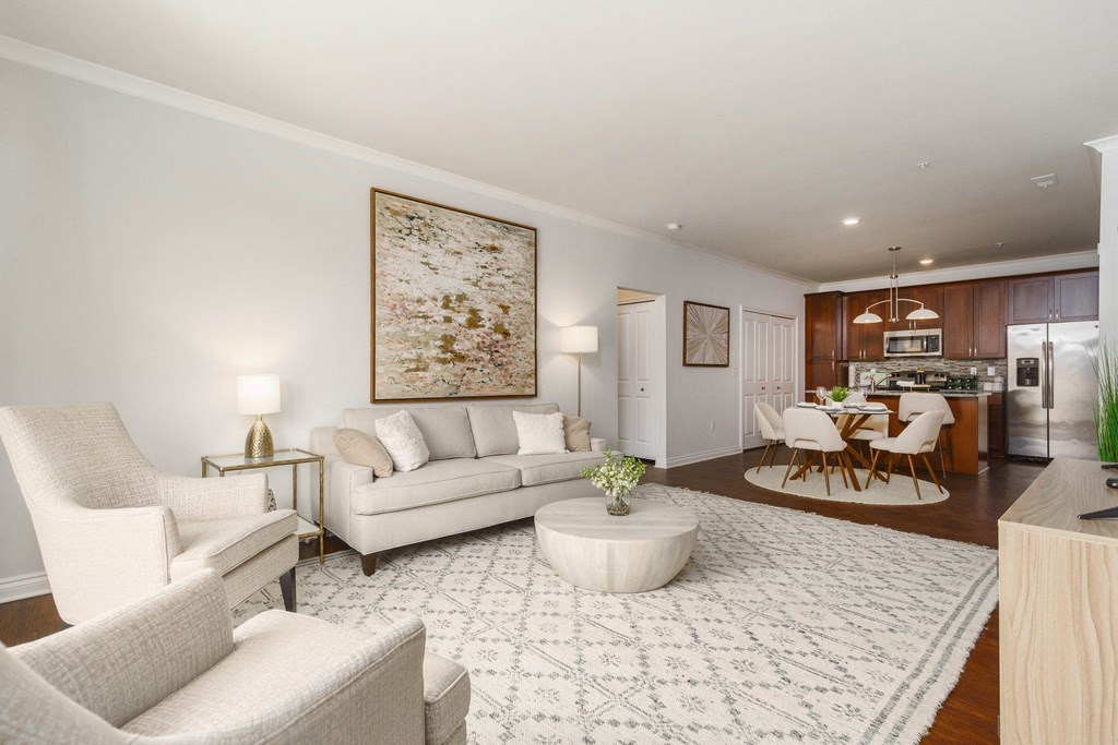 a living room with a couch and chairs and a table