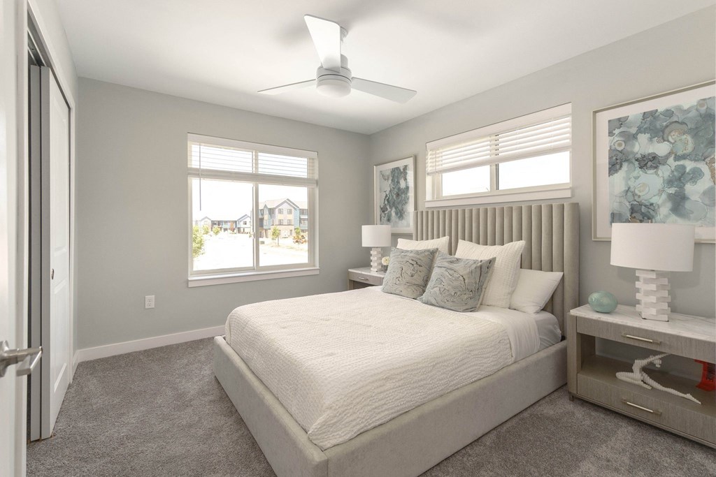 a bedroom with a bed and a ceiling fan