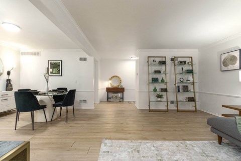 a living room and dining room with a table and chairs