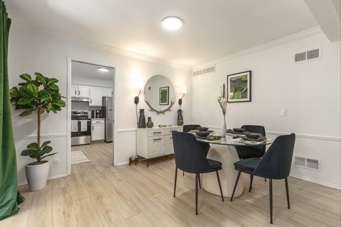 a living room and dining room with a table and chairs