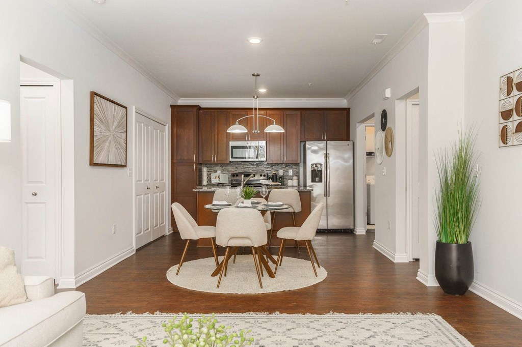 a dining room and kitchen with a table and chairs