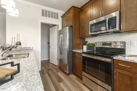 A modern kitchen with wooden cabinets and stainless steel appliances.