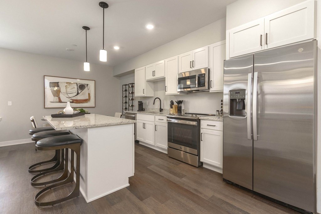 a kitchen with stainless steel appliances and a island with bar stools