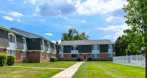 A building with a green lawn in front of it.