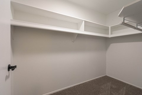 a empty room with a white wall and a white shelf