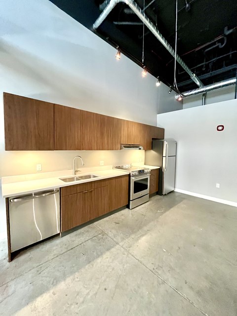 A kitchen with wooden cabinets and stainless steel appliances.