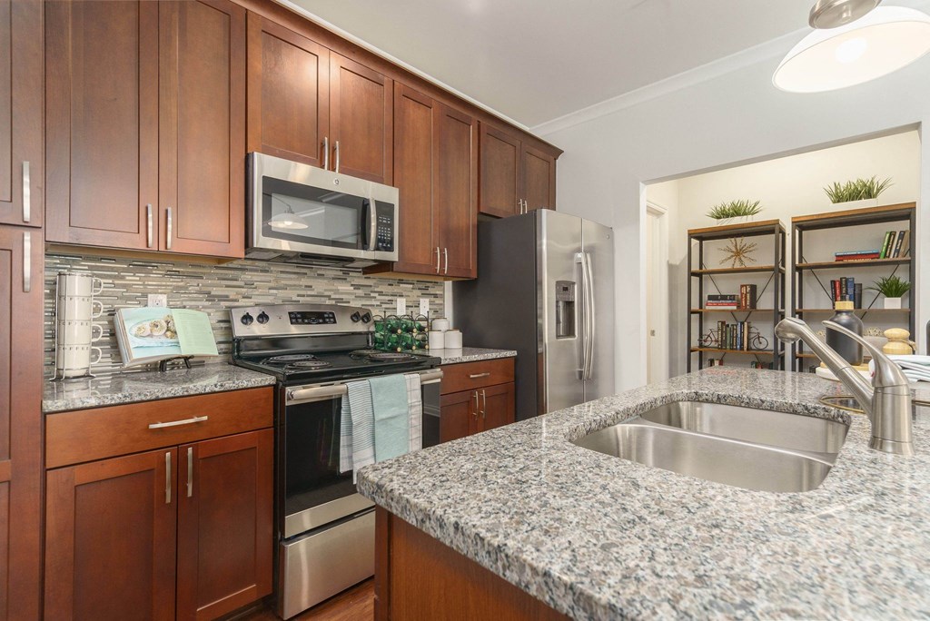 a kitchen with granite counter tops and stainless steel appliances