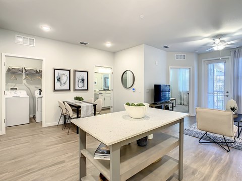 A dining room with a table and chairs.