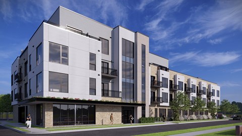A modern building with a white and black exterior and large windows.