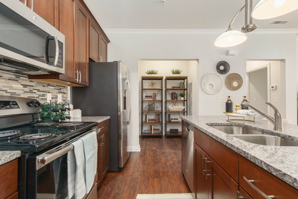 a kitchen with stainless steel appliances and granite counter tops
