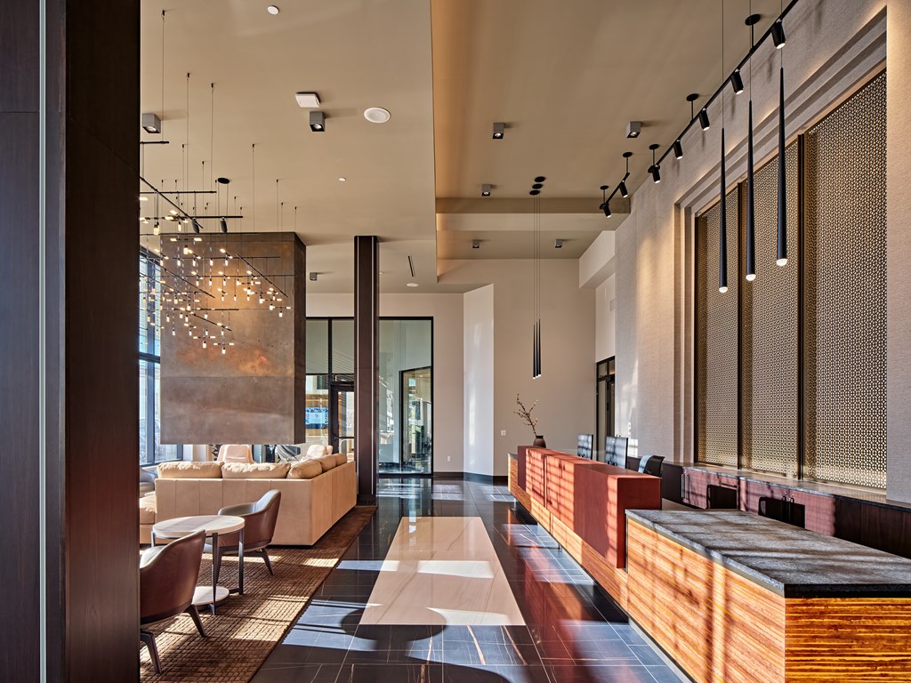 A modern living room with a long wooden bench and a glass door.
