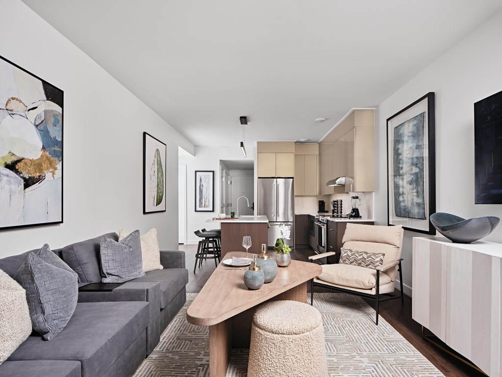 A modern living room with a grey sofa and a wooden coffee table.