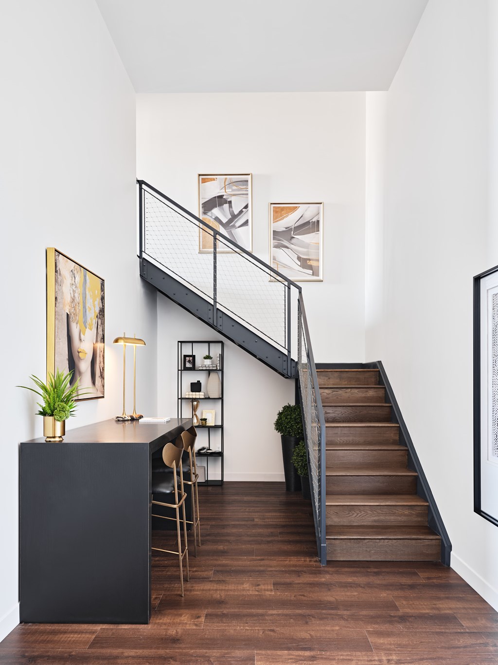 A staircase with a black railing and wooden steps.