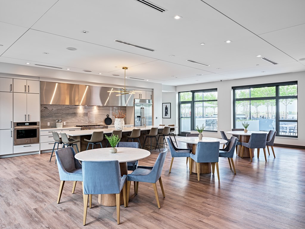 A modern kitchen with a dining table and chairs.