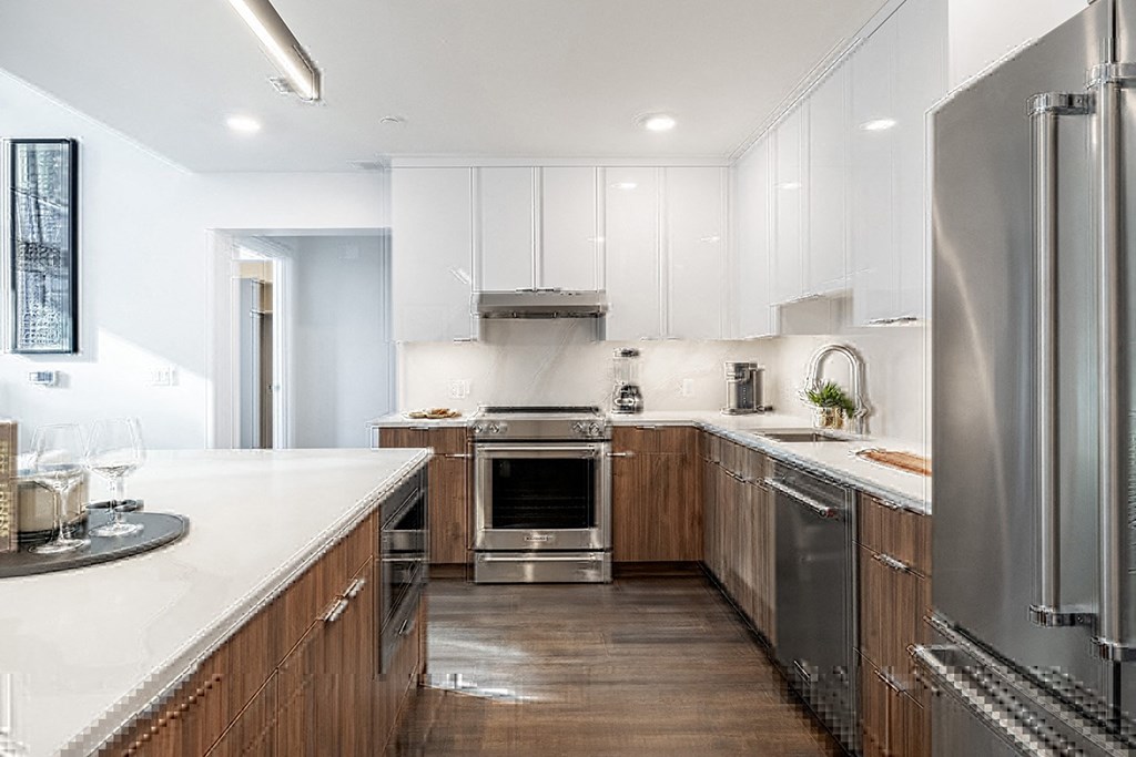 A modern kitchen with wooden cabinets and stainless steel appliances.