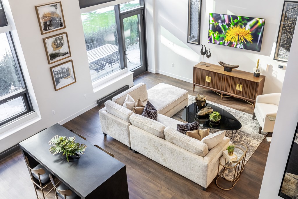 A living room with a couch, coffee table, and pictures on the wall.